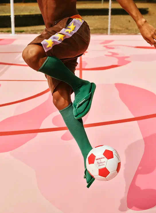 Havaianas Top KidSuper Turf Pitch styled on a football court